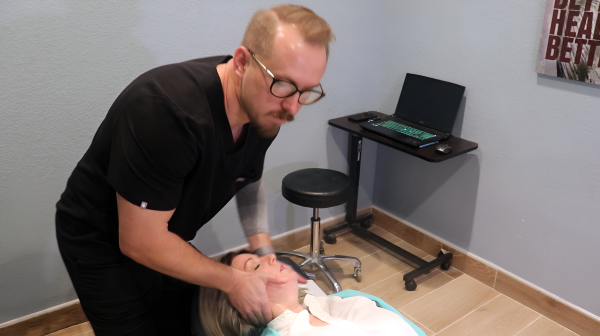 Andrew Yakubik adjusting a patients neck.