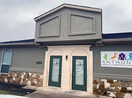 The front of the clinic. It has green doors.