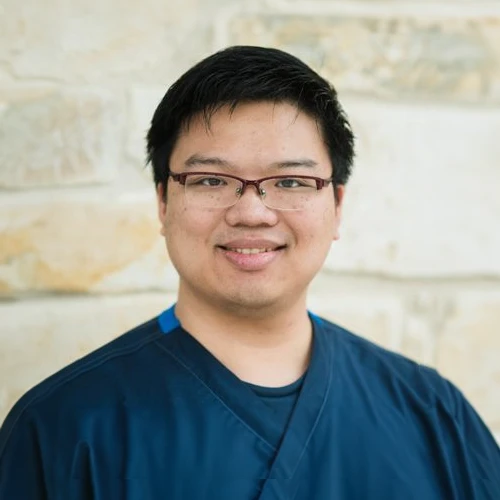 Dr. James smiling in a blue shirt.