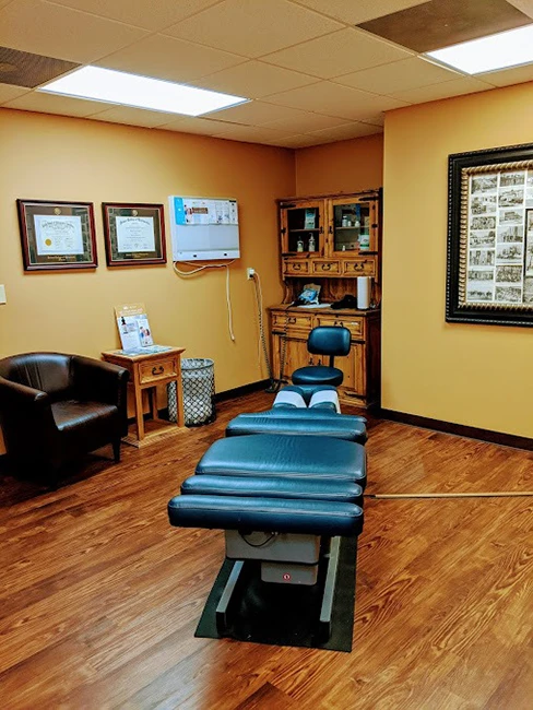 The exam room. There is an adjustment table in the center of it.