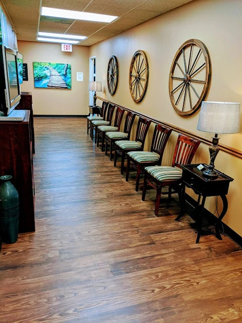 The waiting room has chairs lined against the wall.