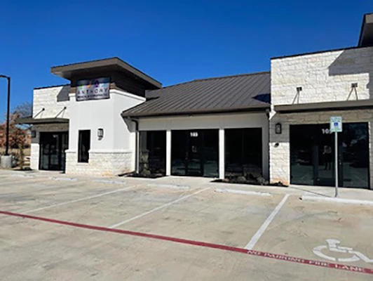 The front of the clinic is made of white brick.