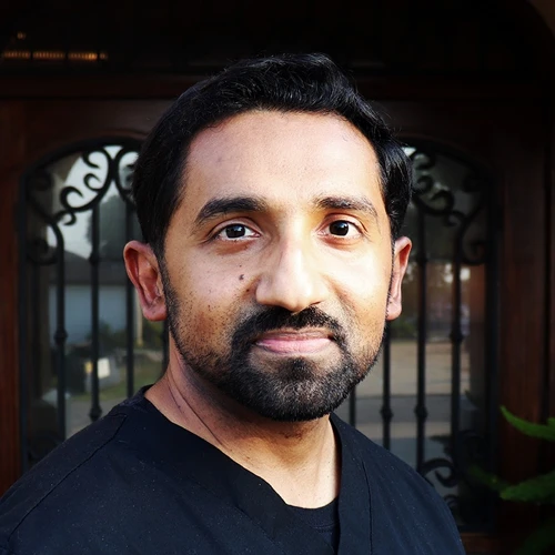 Alex Jolly smiling in a black shirt.